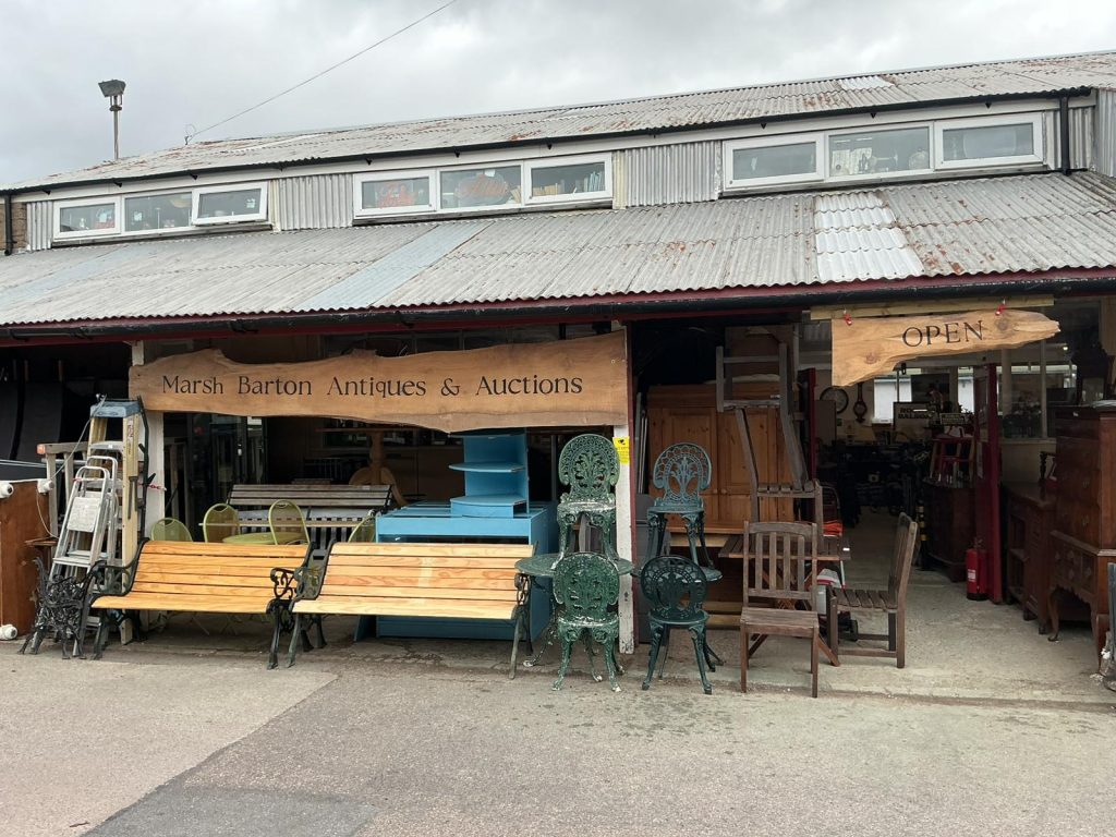 Marsh Barton Antiques & Auctions storefront with antique furniture displayed outside